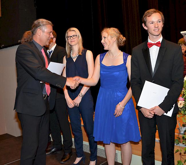 Staatsrat Oskar Freysinger übergibt einer Maturandin aus der 5A ihr Zeugnis.