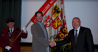 Stabwechsel: Guido Pellanda (rechts) &uuml;bergibt das Verbands-Pr&auml;sidium an Philipp Loretan. Links Verbandsf&auml;hnrich Roland John.