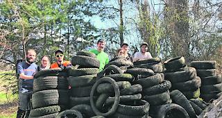 Entsorgt. Eine Gruppe freiwilliger Helfer und eine Vielzahl von eingesammelten weggeworfenen Pneus.  