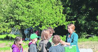 Unterrichtsstunde im Freien. Bevor die 4.-Kl&auml;ssler der Primarschule Steg-Hohtenn die &laquo;Fl&auml;ckler&raquo; pflanzen d&uuml;rfen, f&uuml;hrt Projektleiterin Rachel Imboden die Kinder in die Geschichte und Eigenschaften der Kartoffel ein. 
