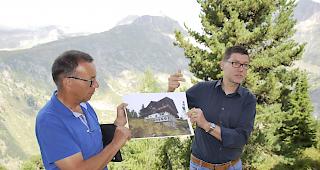 Zentrumsleiter Laudo Albrecht (links) und Innenarchitekt Iwan Ruppen erkl&auml;ren die geplante Montage der Aussenregister f&uuml;r die Luft-/W&auml;rmepumpe an einem Nebengeb&auml;ude des Zentrums. Foto wb